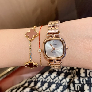 Elegant gold square quartz watch for women with stylish metal link bracelet on wrist