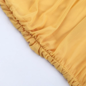 Detail shot of yellow mesh fabric showing intricate ruching and soft textile texture