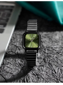 Detail of square green sunray dial and matte black segmented steel strap watch