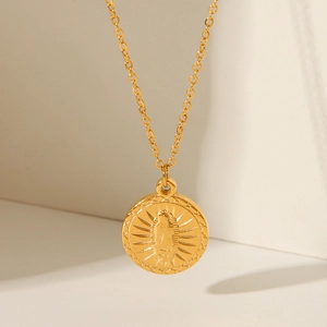 Macro view of 18K gold plated necklace featuring an embossed Guadalupe angel pendant