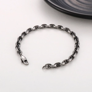 Detail of vintage matte silver pig nose chain link bracelet with retro textured finish