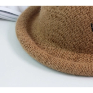 Detailed close-up of the rolled edge and camel wool texture of this kid's vintage felt hat