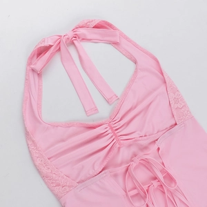 Detailed view of pink lace patchwork halter top with cross-back tie design