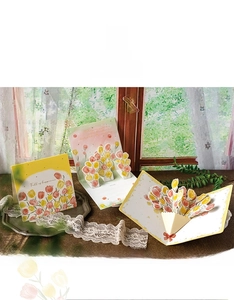 Detailed view of 3D pop-up tulip and carnation greeting cards in bright sunlight
