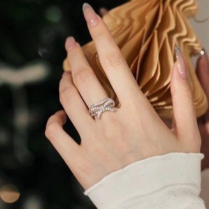 Detailed macro view of S925 sterling silver bow ring with sparkling pavé white diamonds