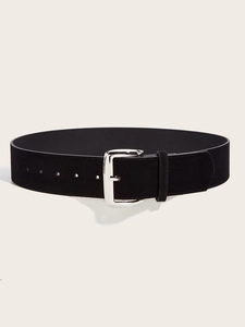 Close-up of black suede wide belt with polished silver metallic buckle and matte texture
