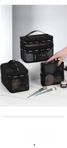 Close-up of black mesh makeup bag set showing layered storage for brushes and skincare