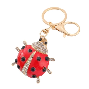 Sparkling ladybug keychain with red enamel wings and white rhinestones on golden ring