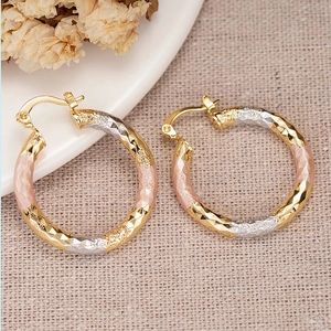 Three-tone hoop earrings with diamond-cut texture in gold, silver, and rose gold finish