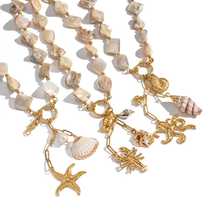 Golden stainless steel ocean theme necklace with shell beads and sea life pendants