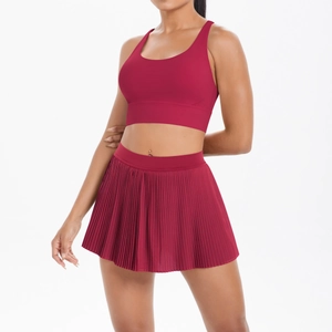 Detail of burgundy sports bra and pleated tennis skirt set on professional model