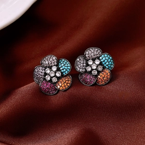 Detailed view of vintage flower stud earrings with multi-color cubic zirconia inlay