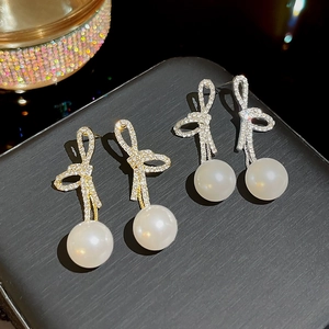 Elegant bow knot pearl drop earrings with rhinestones in gold and silver finish