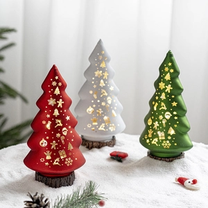 Lighted frosted glass Christmas trees with gold reindeer and snowflake patterns