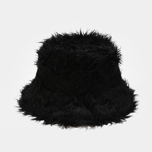 Close-up of black fluffy faux fur bucket hat with soft plush texture for winter warmth