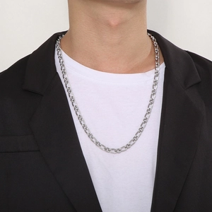 Men's silver Figaro chain necklace in stainless steel worn over a classic white t-shirt