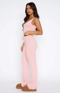 Side view of pink ribbed knit two-piece set featuring V-neck sleeveless top and pants