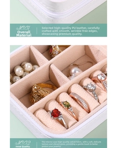 Macro shot of white PU leather jewelry box with pink velvet lining and ring storage slots