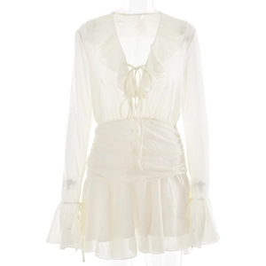 Detailed view of white chiffon V-neck dress with ruffled sleeves and lace-up front detail