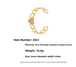 Detail view of gold stainless steel heart bracelet with cubic zirconia and drip oil design