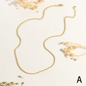 Detail of golden twist rope chain necklace with lobster clasp and adjustable extension