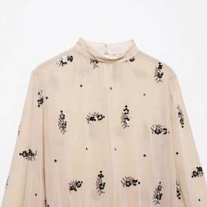 Elegant apricot chiffon blouse for women featuring black sequin floral embroidery and high neck