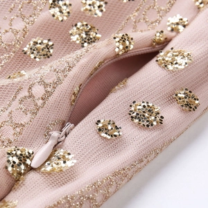 Detail shot of invisible zipper on pink beige mesh dress with gold sequin embroidery
