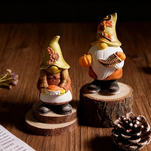 Detailed view of harvest gnome figurines with pumpkin and sunflower on rustic wood