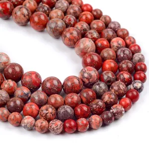 Macro detail of red natural stone round beads with polished marble texture for jewelry