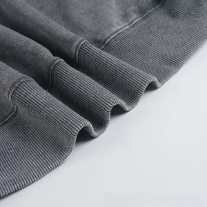 Detail view of the ribbed cuff texture on a washed grey oversized cotton sweatshirt