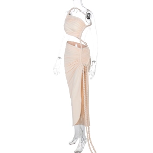Detail of light beige ruched dress featuring hand-woven rope ties and side cut-outs