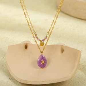 Double-layered gold necklace featuring purple natural stones and heart star pendant