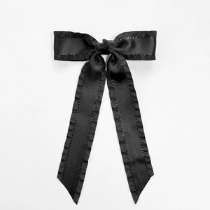 Elegant black grosgrain ribbon bow hair clip with long streamers on a white background
