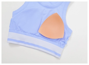Detail of light blue yoga vest with removable pads and striped elastic band