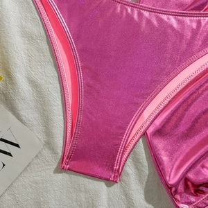 Close-up of metallic pink bikini bottom showing precision double-needle stitching quality