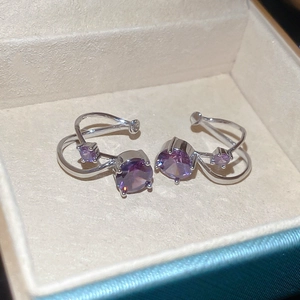 Detail shot of purple zircon double-layer silver ear cuff inside a jewelry display box