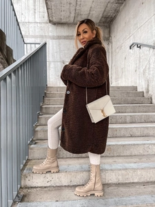 Outdoor shot of brown faux fur coat with lapels and long sleeves on a model