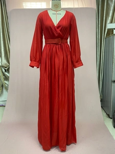 Detail of red deep V-neck maxi dress featuring pleated bodice and square buckle waist belt