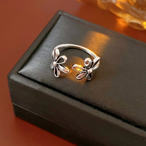 Detailed close-up of retro hollow floral open ring with vintage silver finish on jewelry box