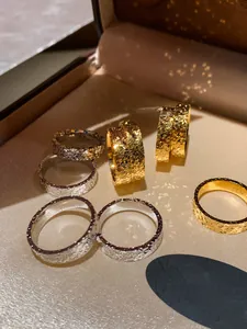 Close-up of 18k gold and silver pleated rings with hammered texture in jewelry box