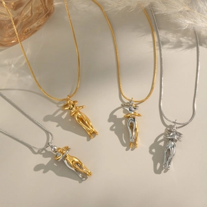 Elegant hugging couple pendant necklaces in gold and silver finishes on snake chains