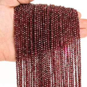 Macro detail of 3mm dark red faceted garnet beads showing natural stone texture