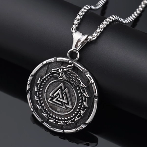 Detailed view of silver Viking pendant with Valknut symbol and Jormungand serpent engraving