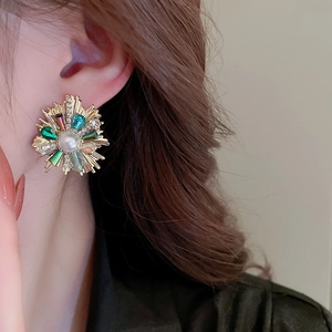 Macro side view of a luxury vintage flower earring with pearls and colorful zircons