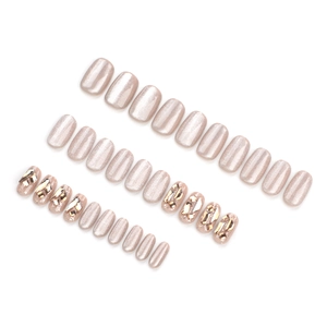 Champagne cat-eye press-on nails set with 3D geometric crystals on white background