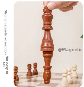 Detail showing strong magnetic attraction feature with wooden chess pieces held upside down