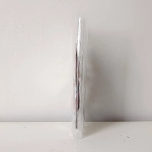 Close-up of a brown Christmas door frame ornament packaged in a transparent bag