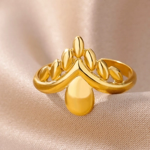 Detailed close-up of 18k gold plated crown ring on champagne silk background