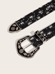 Close-up of vintage Western belt with silver embossed buckle and rivet details