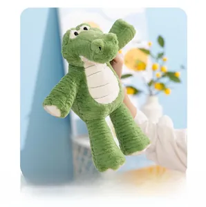 Detailed view of the soft green plush crocodile toy with cream striped belly and paws